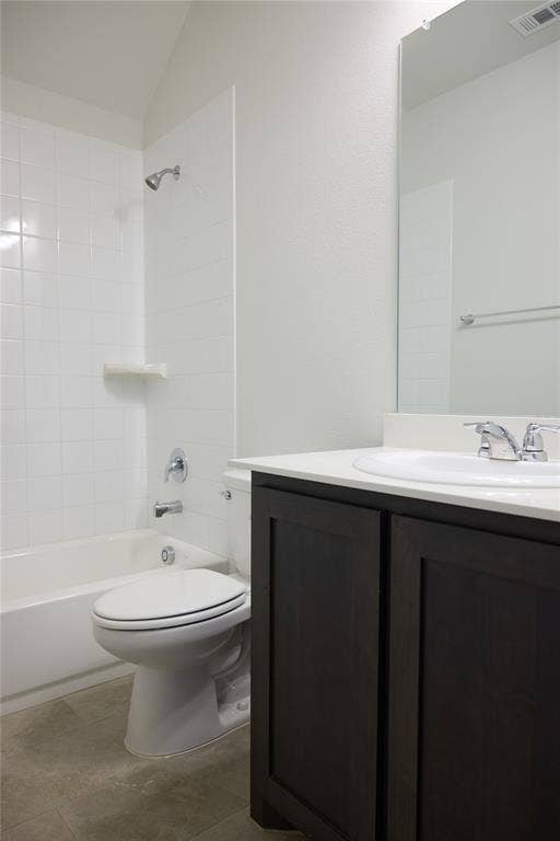 Bathroom featuring a dark wood-finish vanity, white countertop, integrated sink, and a shower-tub combination with white wall tile