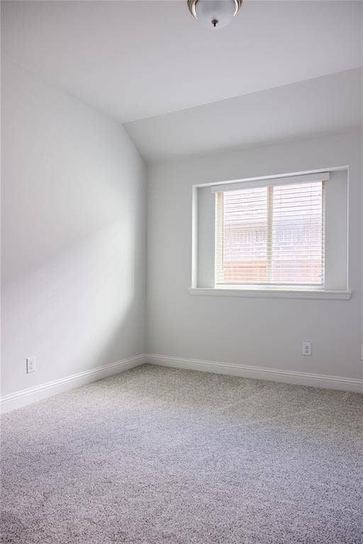 Neutral interior featuring wall-to-wall carpeting, a recessed window with horizontal blinds, and a central ceiling-mounted light fixture