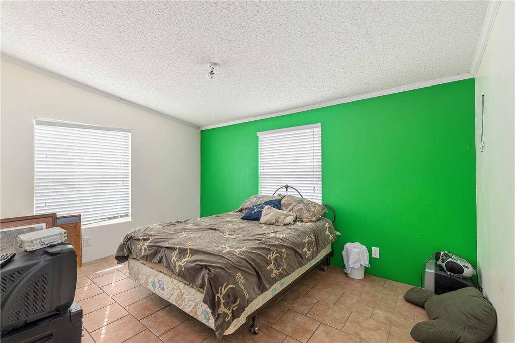 5540 County Road 334, Blanket, TX 76432 Room featuring ceramic tile flooring, dual windows with horizontal blinds, and a central ceiling light fixture