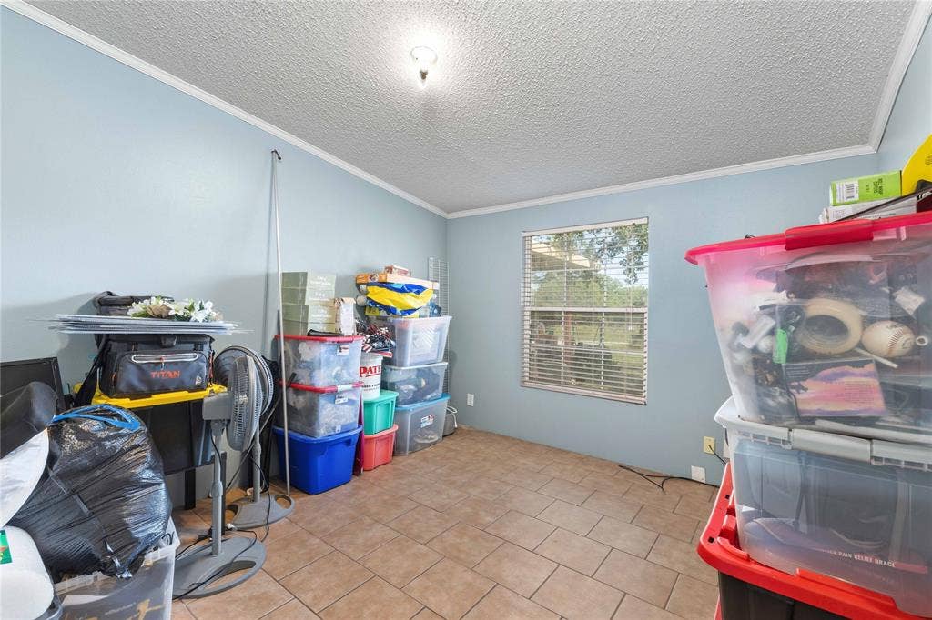 5540 County Road 334, Blanket, TX 76432 Interior room featuring tile flooring, neutral paint, a multi-pane window with blinds, and ceiling-mounted light fixture