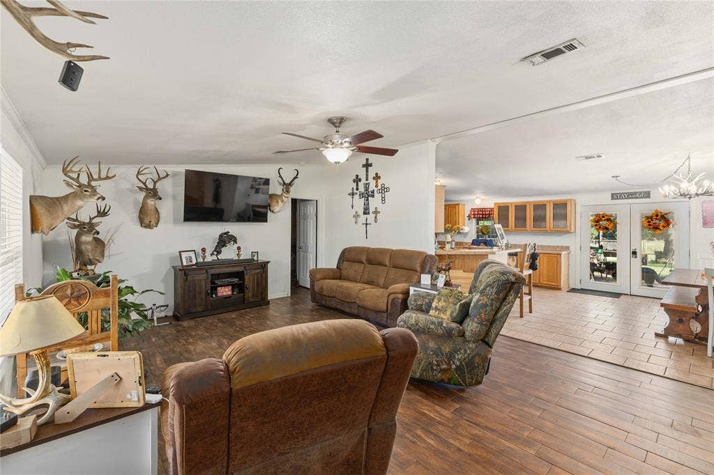 5540 County Road 334, Blanket, TX 76432 Open floor plan featuring wood-finish flooring, recessed lighting, a ceiling fan with integrated light kit, and double French doors