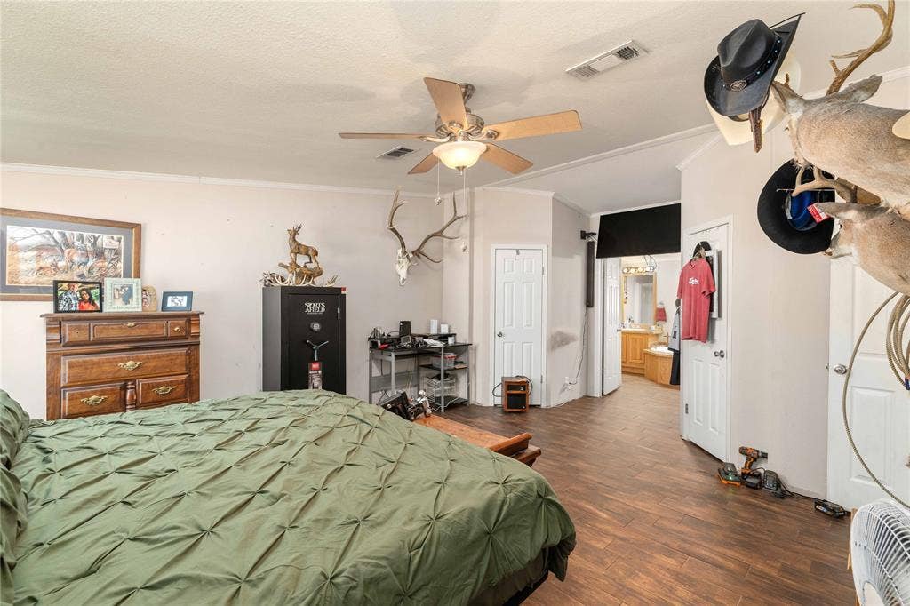 5540 County Road 334, Blanket, TX 76432 Interior space featuring wood-finish flooring, a ceiling fan with integrated lighting, and multiple interior doors with panel detailing