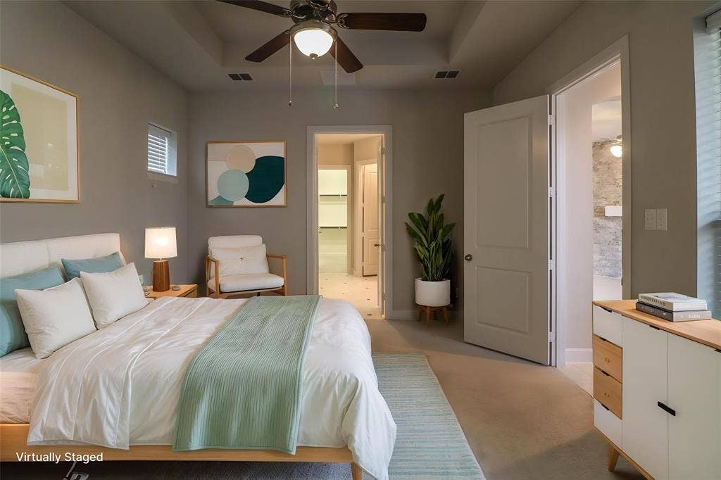Bedroom featuring a tray ceiling, recessed lighting, neutral wall color, and a ceiling fan with integrated light fixture