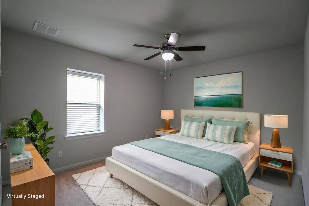 Neutral-toned interior featuring wall-to-wall carpeting, a multi-speed ceiling fan with integrated lighting, and a single-hung window with blinds