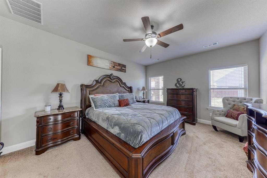 128 Breeders Drive, Willow Park, TX 76087 Spacious room with neutral wall coloring, ceiling fan with integrated lighting, wall-to-wall carpeting, and dual windows with horizontal blinds