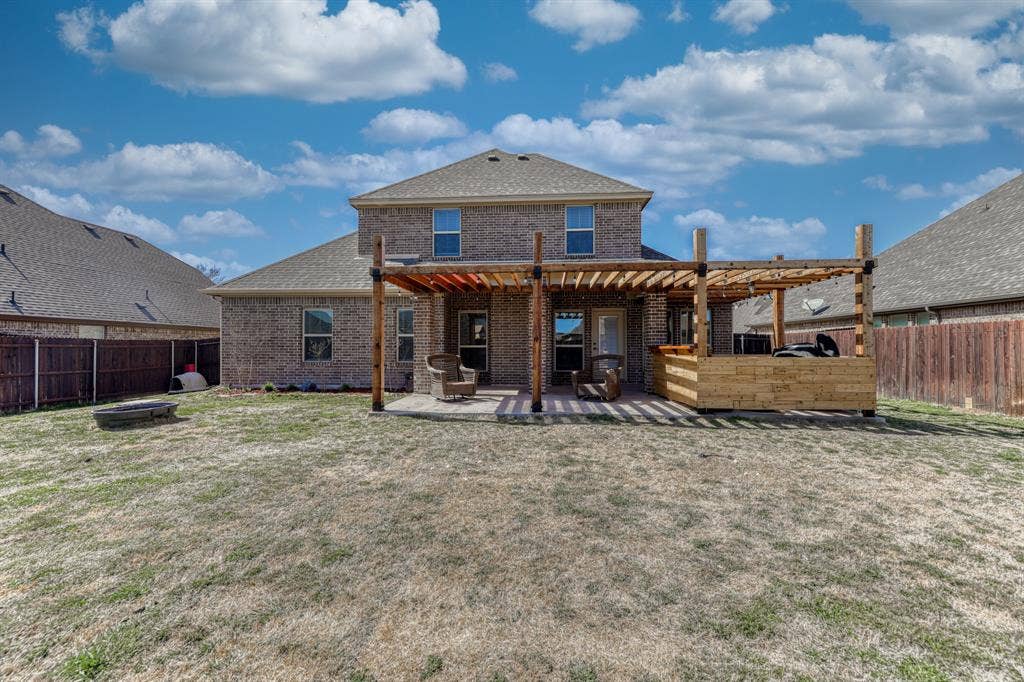 128 Breeders Drive, Willow Park, TX 76087 Brick exterior featuring a wooden pergola, concrete patio, and fenced backyard