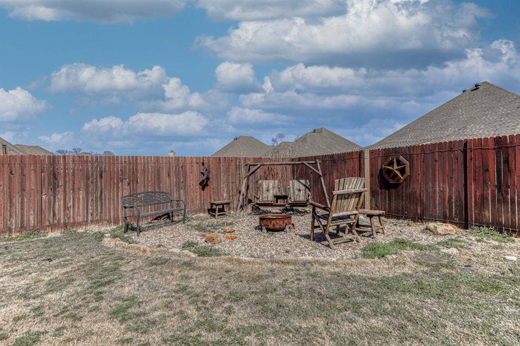 128 Breeders Drive, Willow Park, TX 76087 Backyard featuring a stained wood privacy fence and a gravel-surfaced ground area