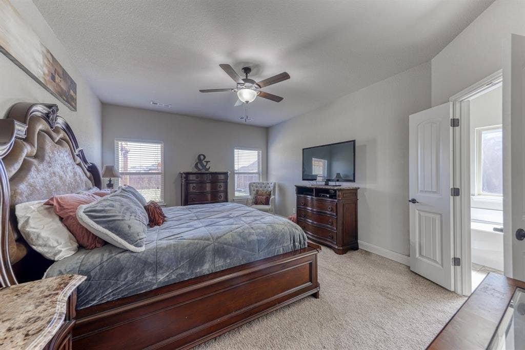 128 Breeders Drive, Willow Park, TX 76087 Neutral-toned room featuring wall-to-wall carpeting, ceiling fan with integrated lighting, and multiple windows