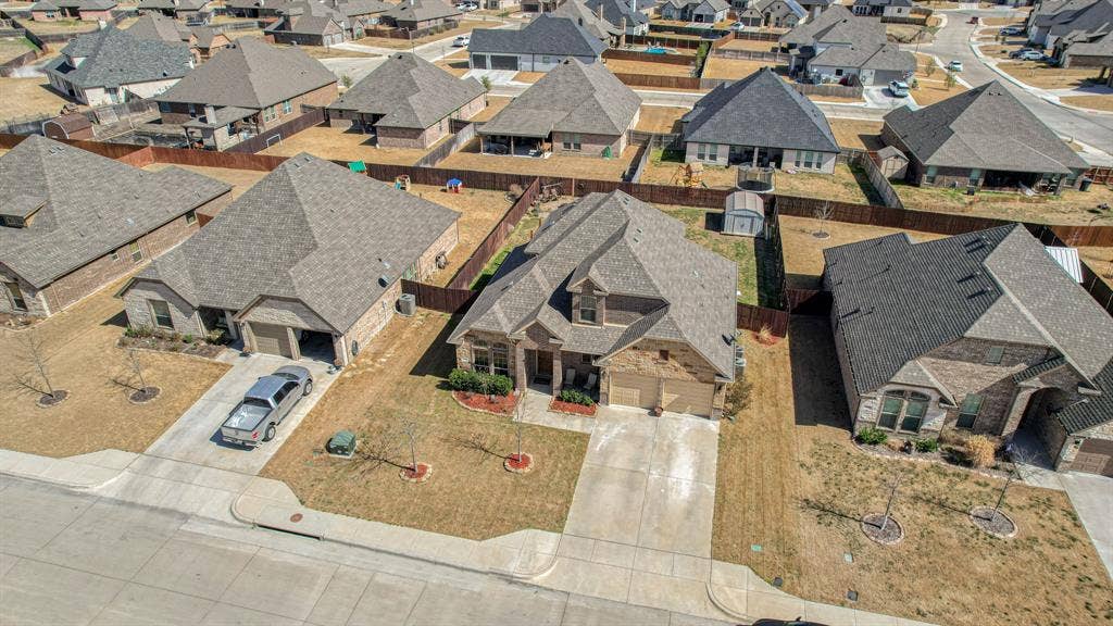 128 Breeders Drive, Willow Park, TX 76087 Single-story residence featuring a brick and stone facade, multi-gabled roofline, two-car garage, and a fenced backyard