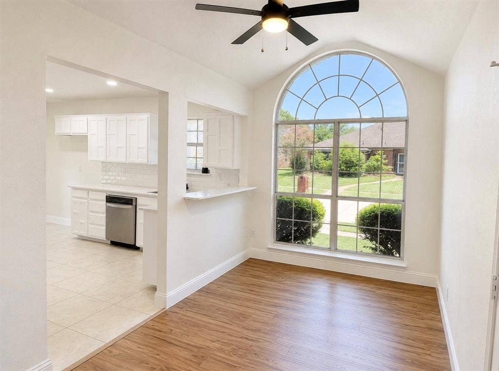 2400 Waterloo Lane, Mesquite, TX 75181 Vaulted ceilings, large arched window, wood-finish flooring, and built-in ceiling fan