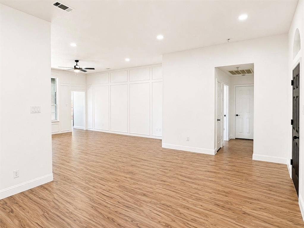 2400 Waterloo Lane, Mesquite, TX 75181 Open-concept interior featuring wood-finish flooring, wainscot wall paneling, recessed lighting, and a ceiling fan