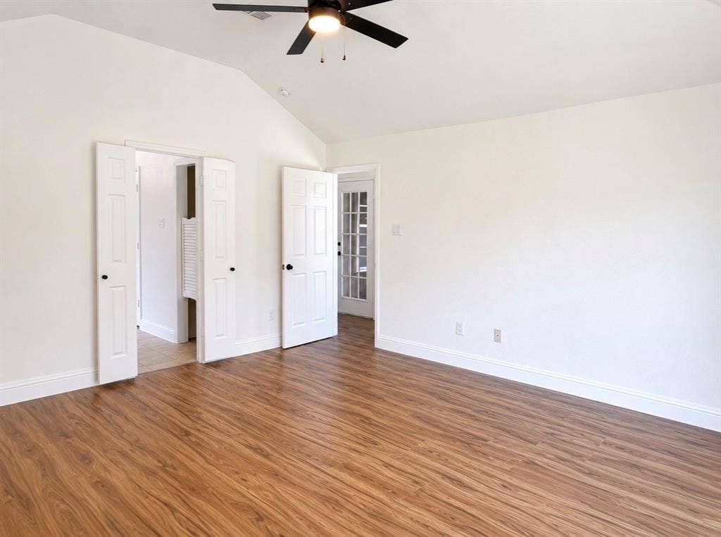 2400 Waterloo Lane, Mesquite, TX 75181 Vaulted ceilings, wood-finish flooring, ceiling fan with integrated lighting, multi-panel interior doors, and a glass-paneled exterior door