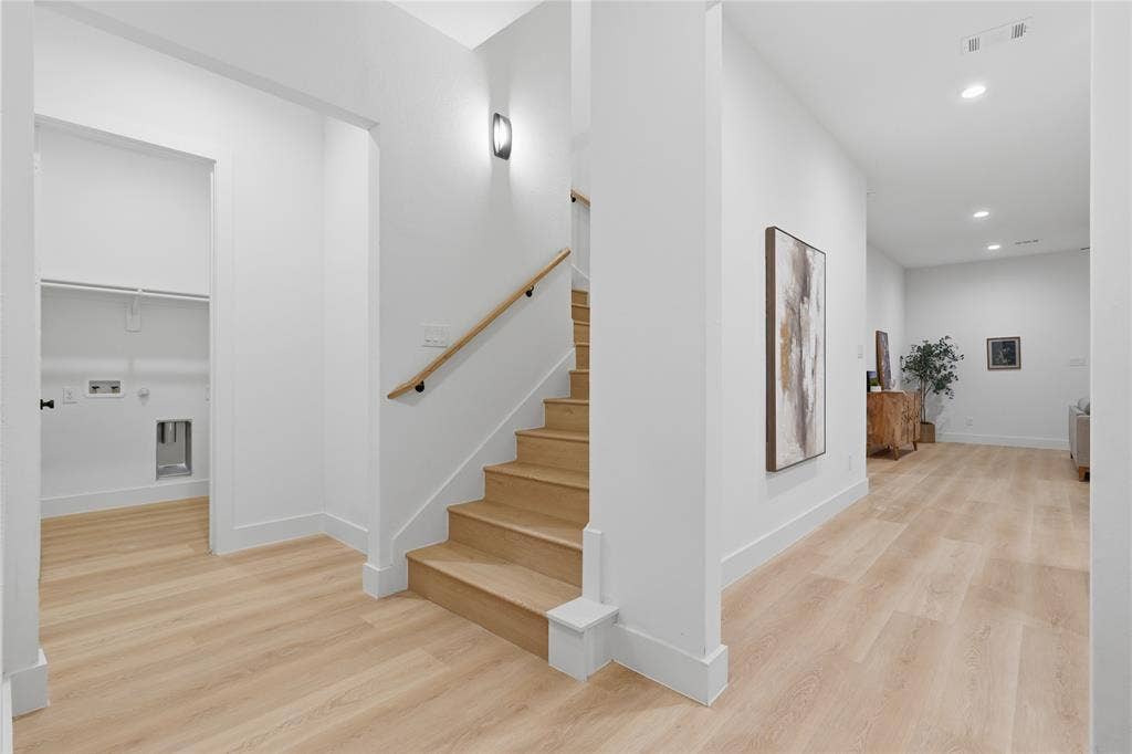 1834 Gallagher Street, Dallas, TX 75212 Interior featuring wood-finish flooring, staircase with a wood handrail, recessed lighting, and a utility space with plumbing connections