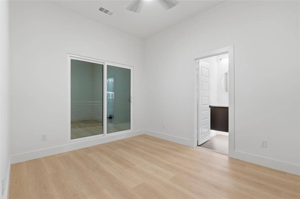 1834 Gallagher Street, Dallas, TX 75212 Room featuring wood-finish flooring, high ceilings with a mounted ceiling fan, and sliding glass doors