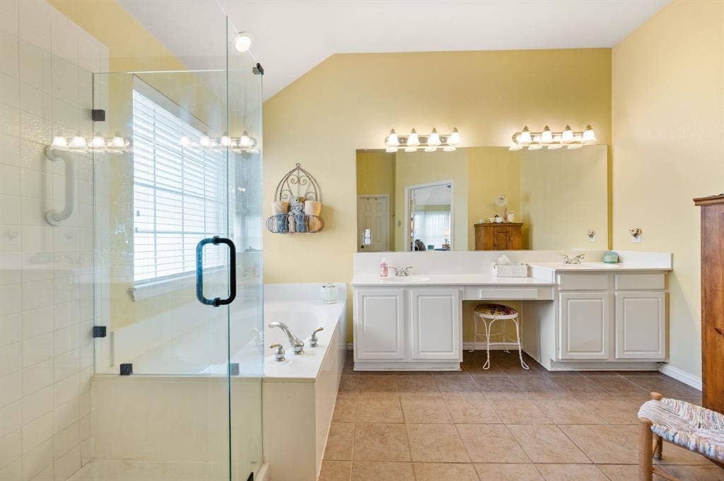Primary bath with garden tub, separate shower, sit down vanity area