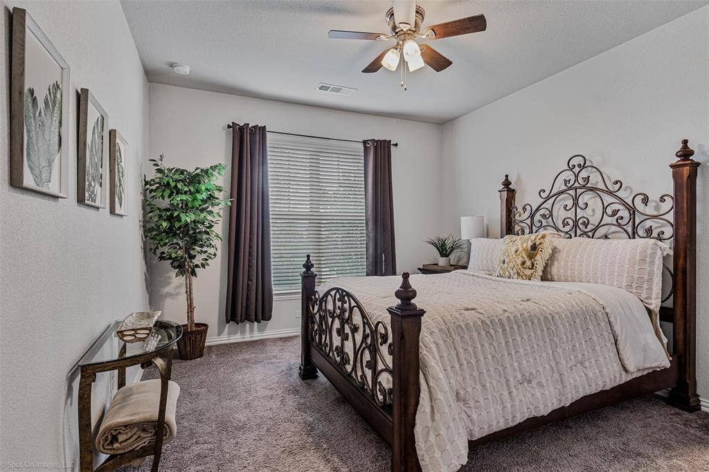 1612 Village Creek Drive, Forney, TX 75126 Carpeted bedroom with ceiling fan and baseboards