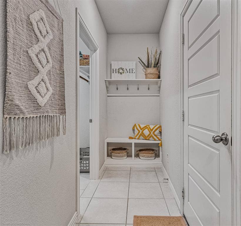 1612 Village Creek Drive, Forney, TX 75126 Mudroom featuring light tile patterned floors and baseboards