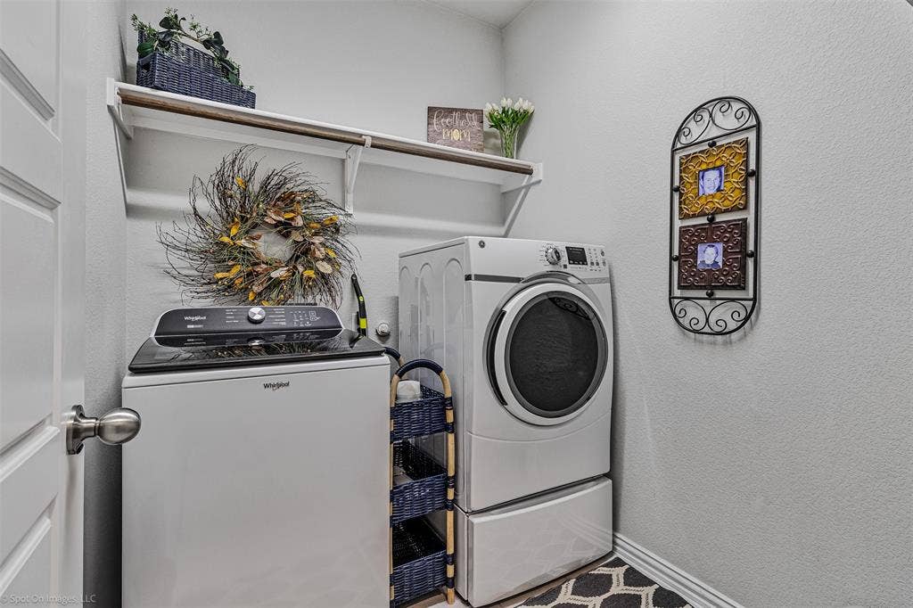 1612 Village Creek Drive, Forney, TX 75126 Washroom with washer and clothes dryer