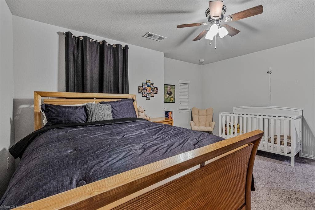1612 Village Creek Drive, Forney, TX 75126 Carpeted bedroom featuring ceiling fan