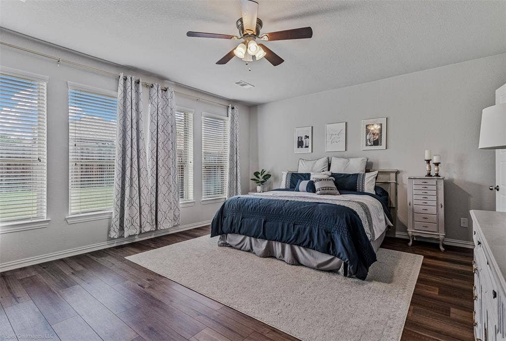 1612 Village Creek Drive, Forney, TX 75126 Bedroom featuring dark wood finished floors and a ceiling fan