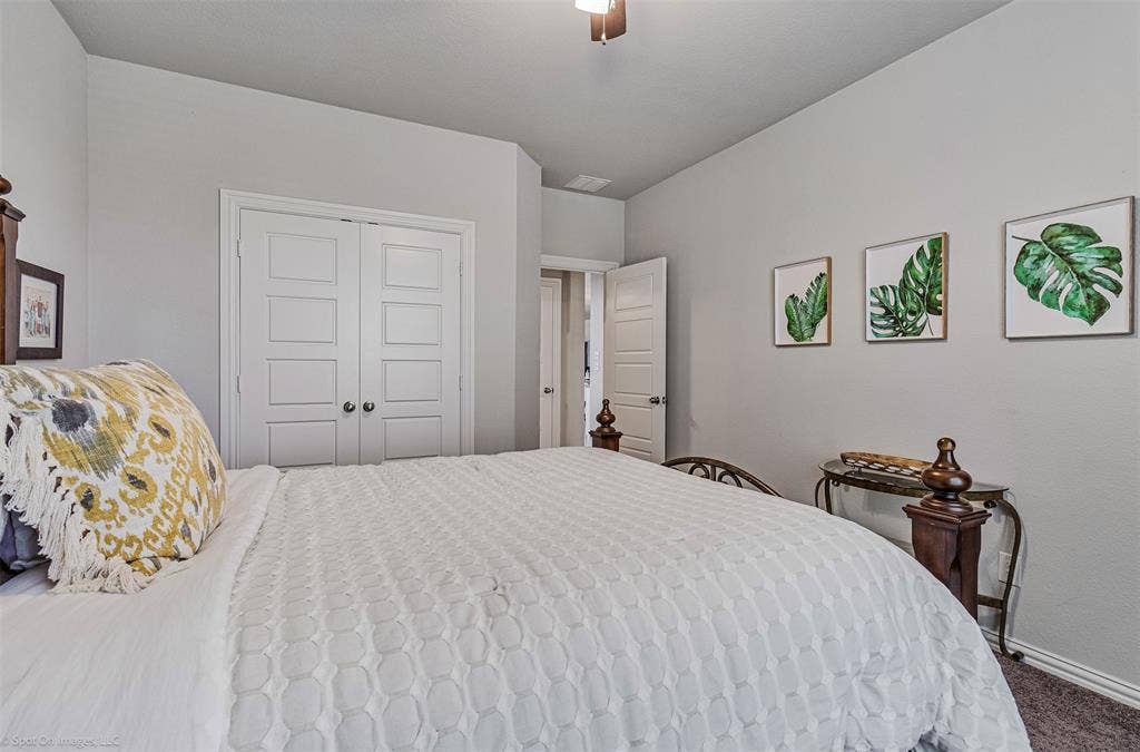 1612 Village Creek Drive, Forney, TX 75126 Carpeted bedroom featuring a closet and a ceiling fan