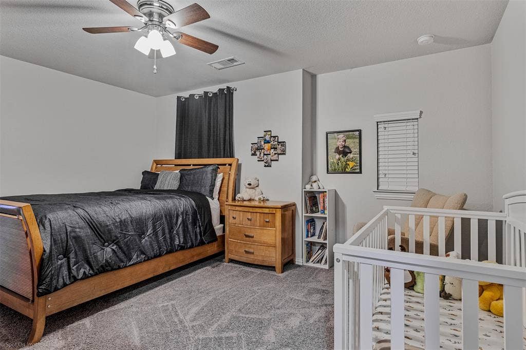 1612 Village Creek Drive, Forney, TX 75126 Carpeted bedroom featuring ceiling fan