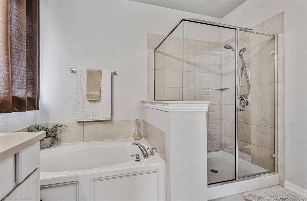1612 Village Creek Drive, Forney, TX 75126 Full bathroom with a bath, a shower stall, and vanity