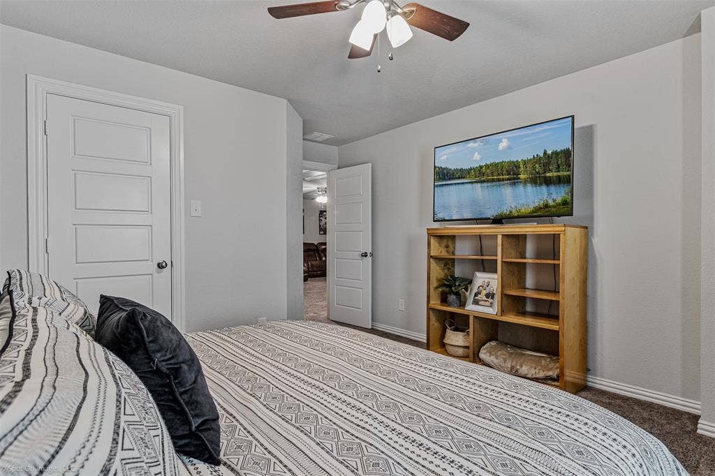 1612 Village Creek Drive, Forney, TX 75126 Bedroom with carpet flooring and ceiling fan
