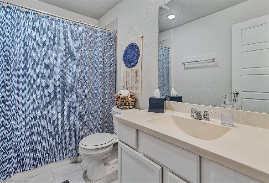 1612 Village Creek Drive, Forney, TX 75126 Full bathroom featuring tile patterned flooring, vanity, and curtained shower