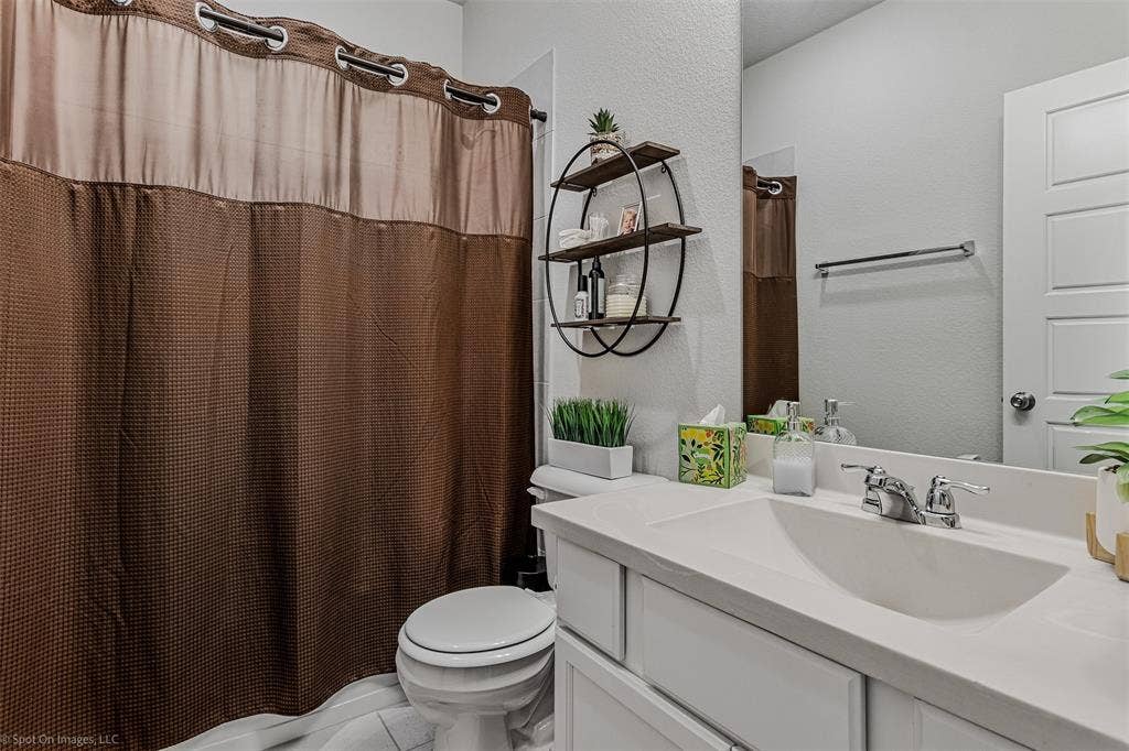 1612 Village Creek Drive, Forney, TX 75126 Bathroom featuring vanity, a shower with curtain, and a textured wall