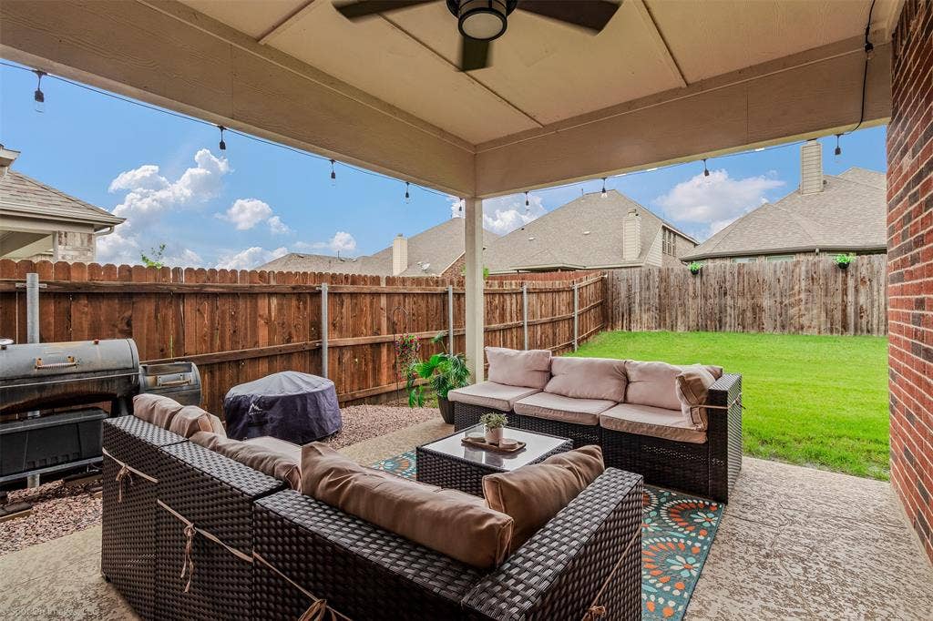 1612 Village Creek Drive, Forney, TX 75126 Fenced backyard with an outdoor hangout area, area for grilling, and a patio