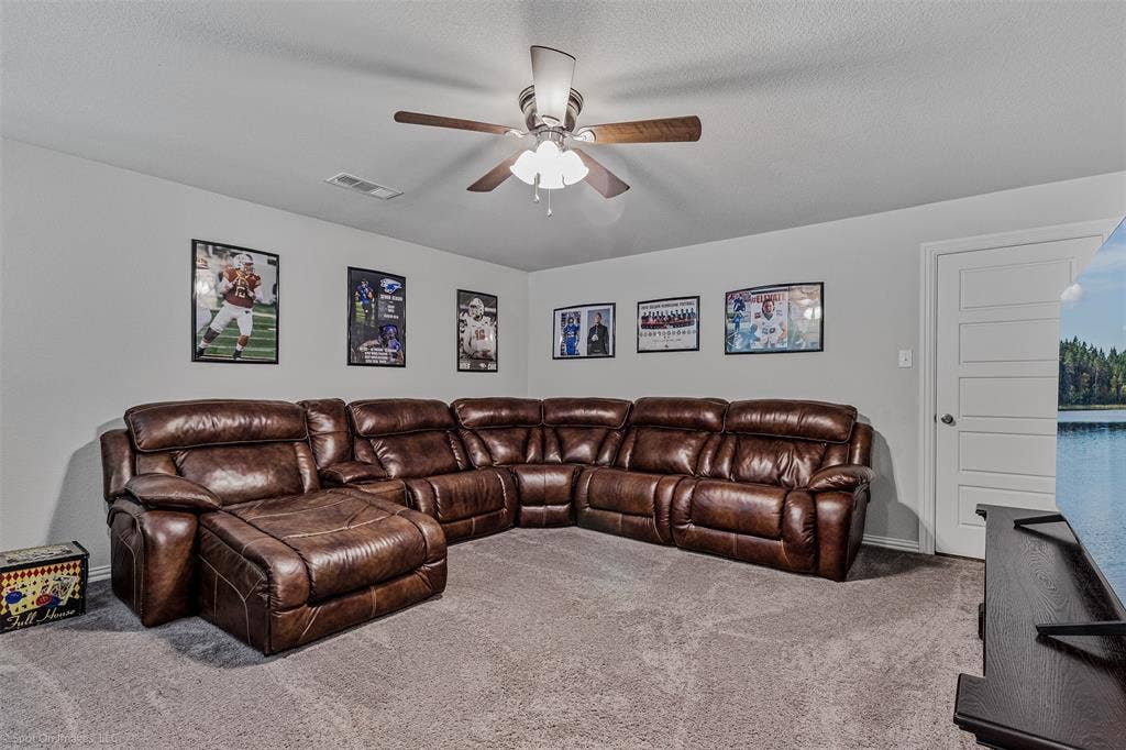 1612 Village Creek Drive, Forney, TX 75126 Carpeted living area featuring ceiling fan