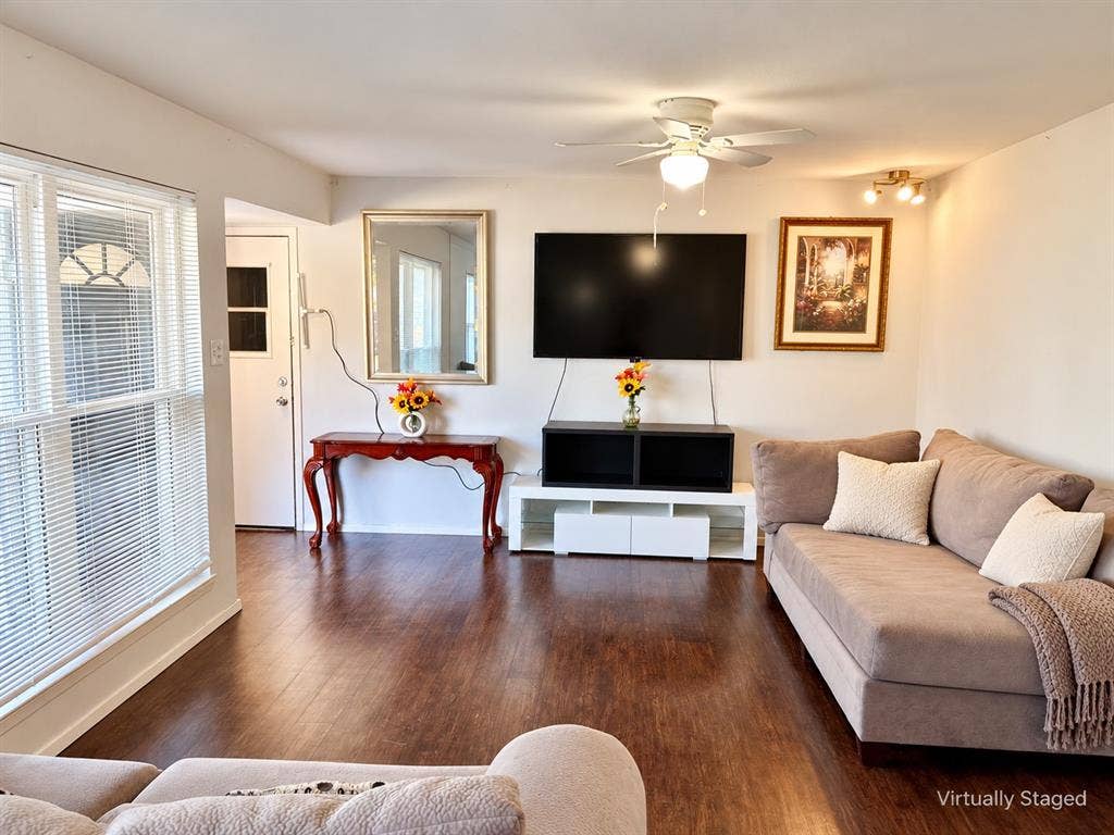 Living area featuring wood-finish flooring, recessed lighting, and a ceiling fan with integrated light fixture