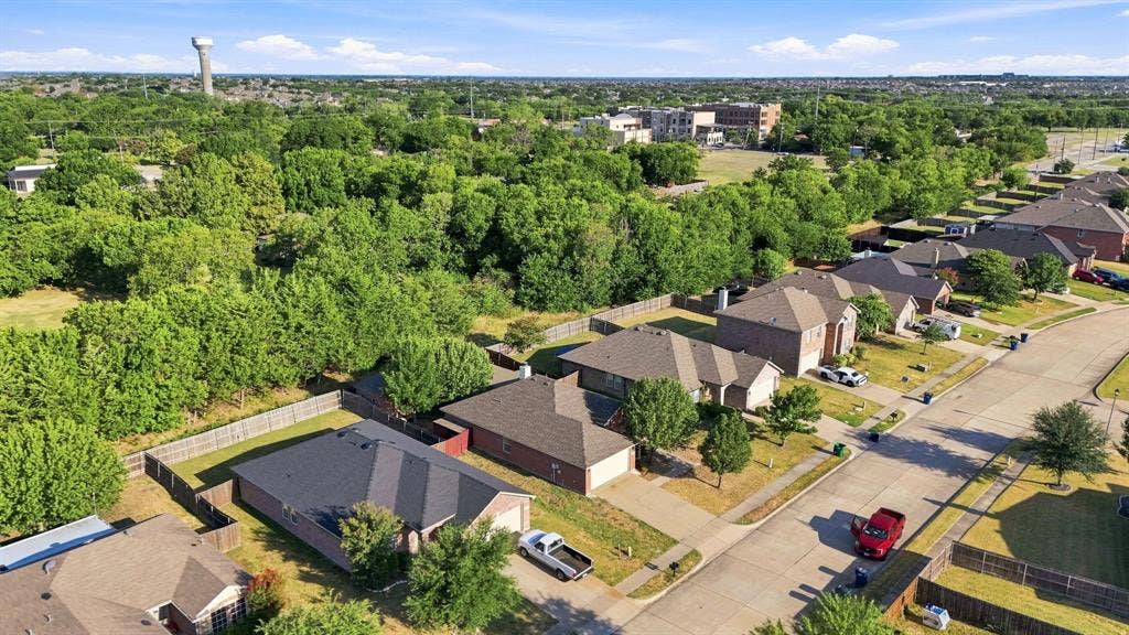 Aerial perspective featuring brick exteriors, multi-hip rooflines, and paved residential streets