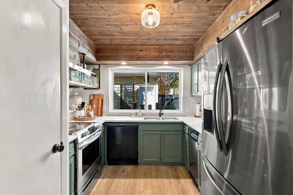 1955 Shorewood Drive, Grapevine, TX 76051 Kitchen featuring wood-paneled ceiling, custom sage green cabinetry, stainless steel appliances, quartz countertops, and wood-finish flooring