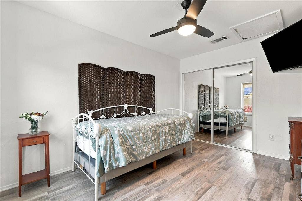 1955 Shorewood Drive, Grapevine, TX 76051 Wood-finish flooring, ceiling fan with integrated light, and sliding mirrored closet doors