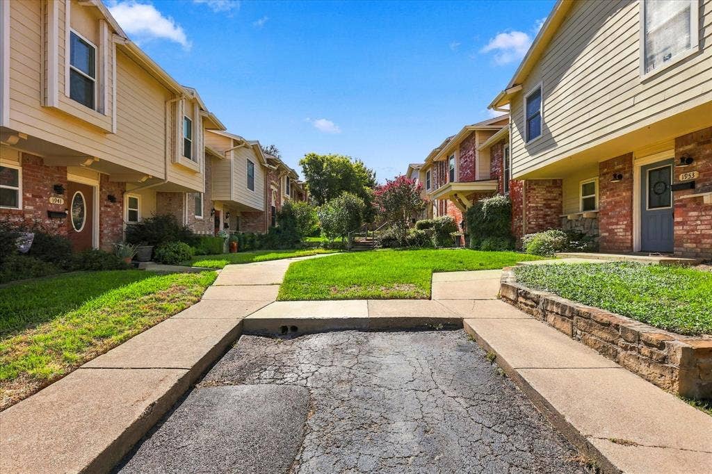 1955 Shorewood Drive, Grapevine, TX 76051 Multi-unit exterior featuring a combination of brick and horizontal siding, stacked structural design, and concrete walkways