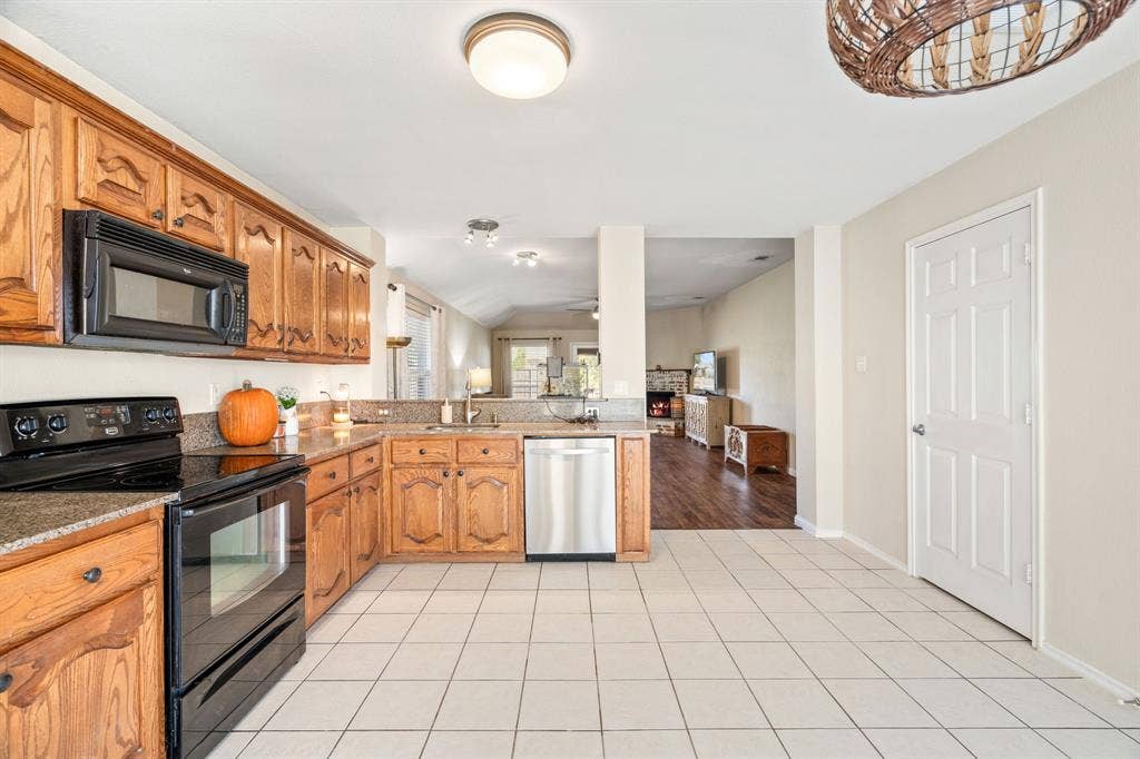 2750 Chalmers Court, Rockwall, TX 75032 The kitchen sink overlooks the dining area and family room