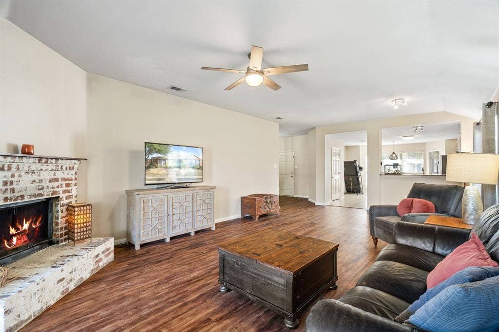 2750 Chalmers Court, Rockwall, TX 75032 The expansive family room features a gorgeous gas fireplace. and a ceiling fan complete with remote.