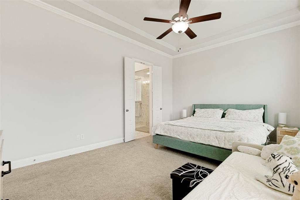 16931 Maple Bend Drive, Frisco, TX 75035 Tray ceiling with crown molding, ceiling fan with integrated light fixture, and double door entry