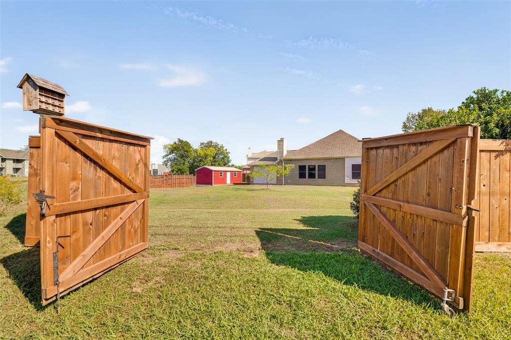 8700 Broken Bow Drive, Greenville, TX 75402 Expansive backyard featuring a rear double-gate entry, and the shop across this huge lot.
