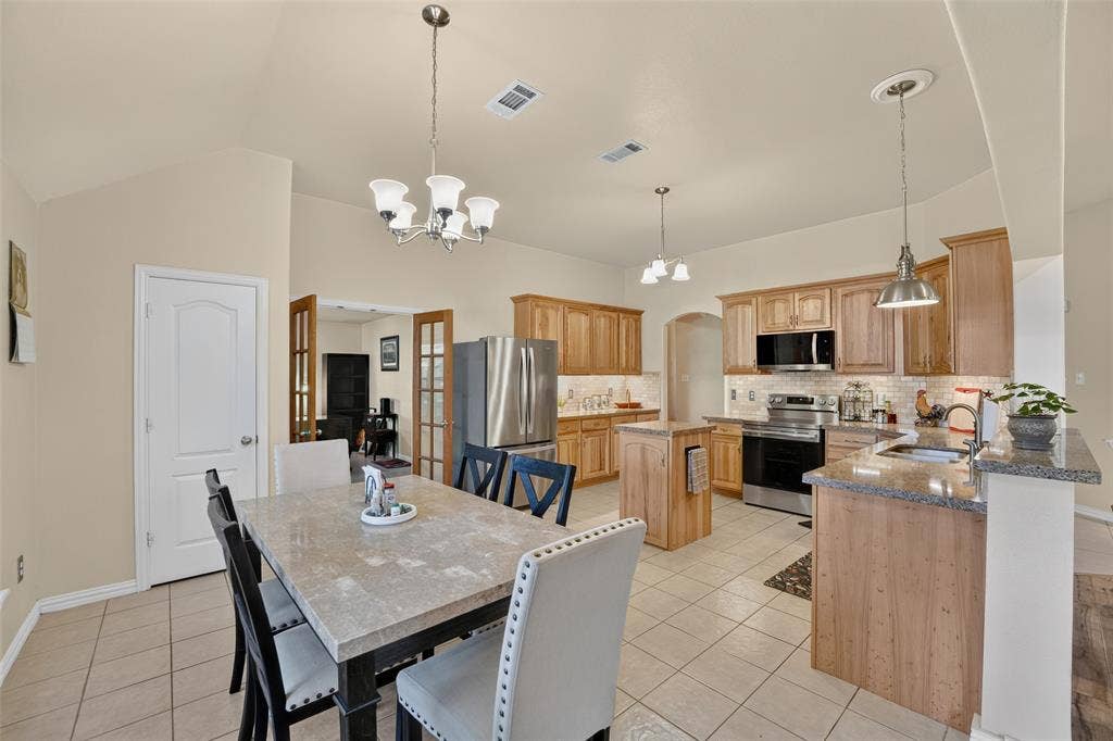 8700 Broken Bow Drive, Greenville, TX 75402 This Kitchen was made for a lot of good cooking using the stainless steel appliances - fridge conveys!