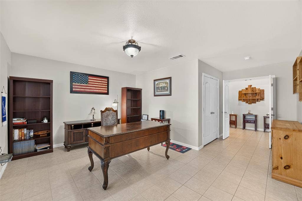 8700 Broken Bow Drive, Greenville, TX 75402 Versatile private study with abundant space for a home office, library, or flex room to fit your lifestyle. Inner double doors lead to a second pantry. Outer doors lead to hallway.