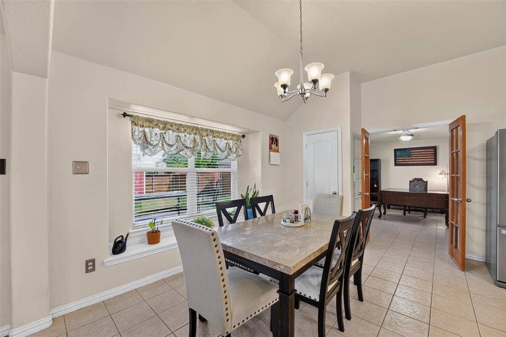 8700 Broken Bow Drive, Greenville, TX 75402 Spacious dining room with vaulted ceiling, large picture window with a charming window seat, and abundant natural light.