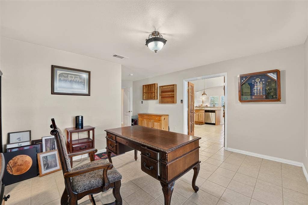 8700 Broken Bow Drive, Greenville, TX 75402 More double doors lead to the kitchen/dining area.
