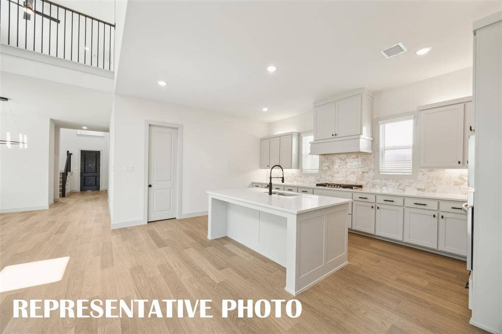 With a floor plan designed for entertaining, the chef in the family will never be left out of the party in this wonderful home!  REPRESENTATIVE PHOTO