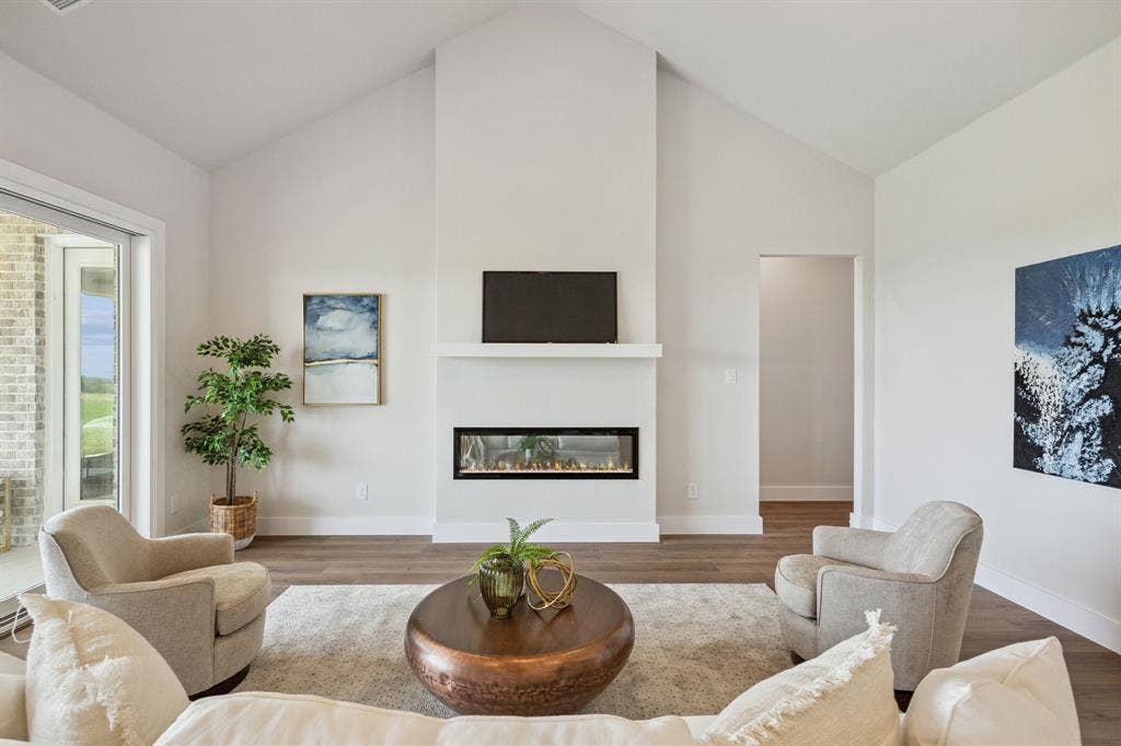 151 Quiet Waters Way, Waxahachie, TX 75165 Vaulted ceilings, linear fireplace with a minimalist mantel, and wood-finish flooring