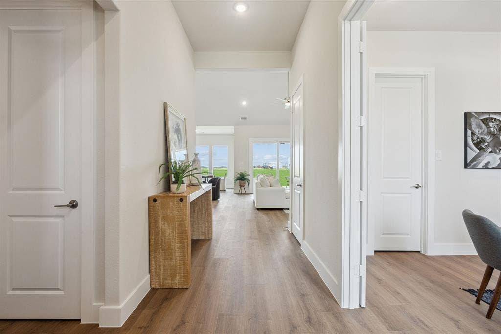 151 Quiet Waters Way, Waxahachie, TX 75165 Interior hallway featuring wood-finish flooring, white panel doors, and recessed lighting