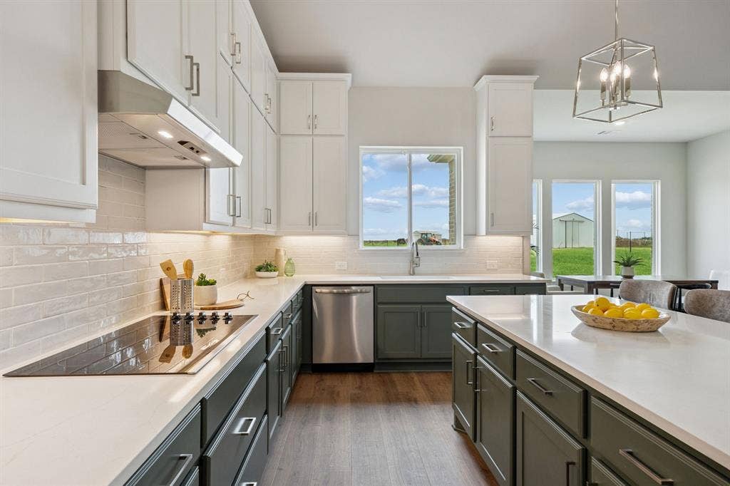 151 Quiet Waters Way, Waxahachie, TX 75165 Kitchen featuring dual-tone cabinetry, quartz countertops, white subway tile backsplash, stainless steel appliances, and wood-finish flooring