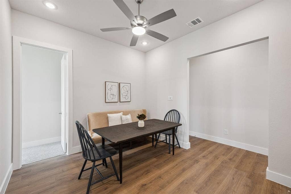 151 Quiet Waters Way, Waxahachie, TX 75165 Wood-finish flooring, brushed nickel ceiling fan with integrated lighting, and recessed ceiling lights